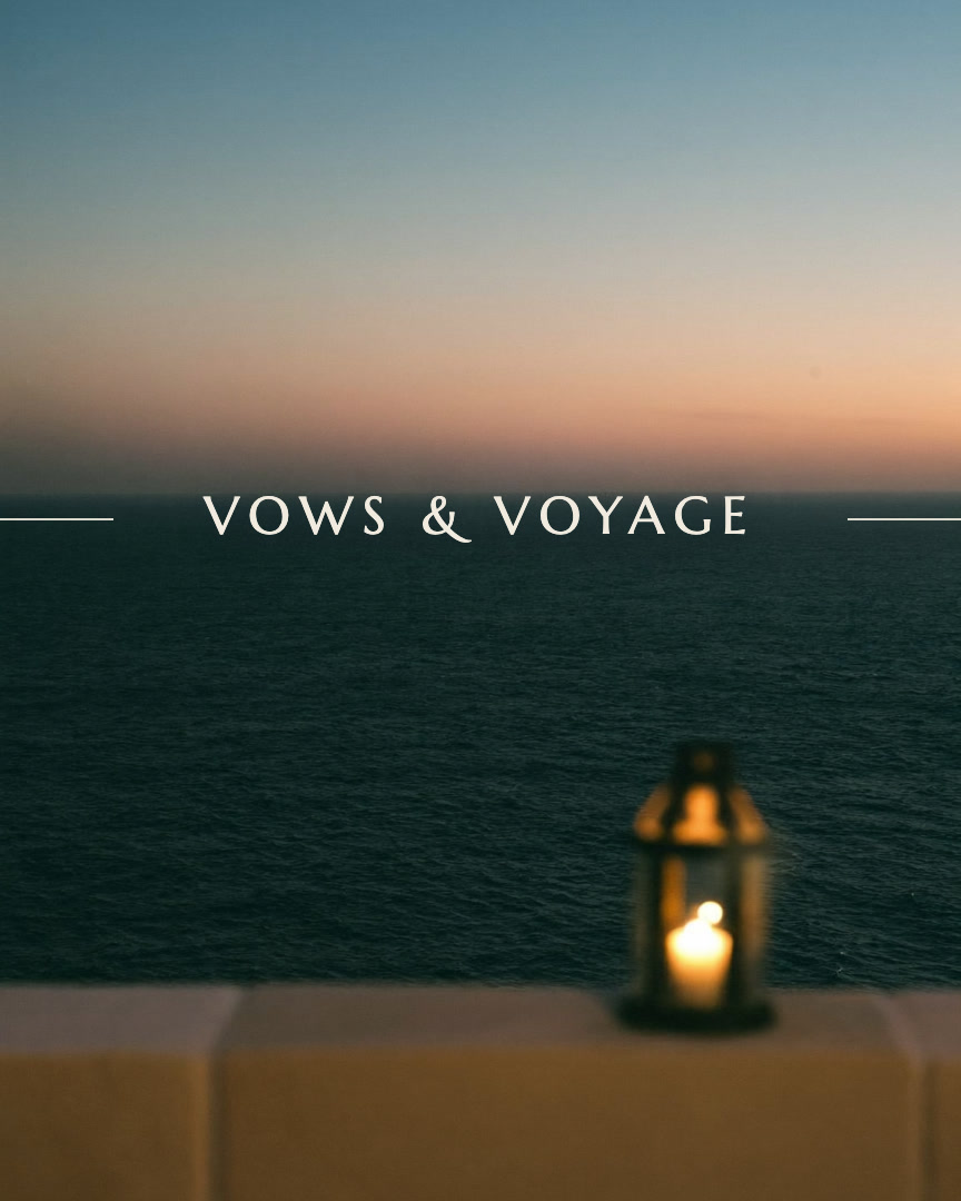 Vows and Voyage brand film still: the wordmark resting on a blue-hour sea horizon above a limestone terrace
